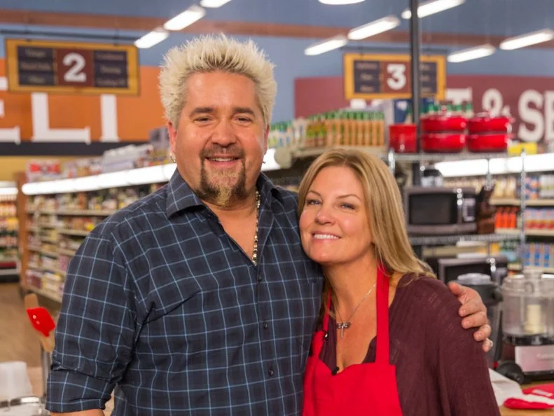Host Guy Fieri with Wife Lori Fieri, as seen on Food Network's Guy's Grocery Games, Season 5.