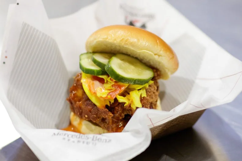 This tasty chicken sandwich, available at West Nest on the 300 concourse, is one of the city's best, either inside or outside the stadium. A juicy Prestige Farms chicken thigh is dredged in flour seasoned with 17 herbs and spices (some of which are grown in the on-site garden) before being fried to golden brown. The sandwich comes tucked into a challah bun dressed with refrigerated pickles, honey hot sauce and Doux South chow chow. Fun (and useful) fact: In-the-know guests can request a gluten-free version and the team will happily accommodate. The always-busy stand is staffed by graduates of Westside Works, a community job-training program helping revitalize the neighborhoods surrounding the stadium.