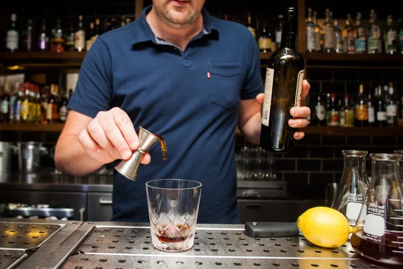 Austin's craft cocktail renaissance means there's a dozen places to find a perfect old fashioned, but it can be tough to find the right balance between vibe, menu and hospitality. Small Victory isn't easy to locate — the long, shotgun-style one-room bar sits at the top of a spiral staircase over a nondescript parking garage — but once you're there it's like entering a Prohibition-era haunt without the pretension of most speakeasy-style bars. Snack on one of the city's best meat and cheese plates while you enjoy signature drinks like the Artists' Special, a smoky variation on the whiskey sour with Scotch, sherry, lemon juice and grenadine. And if you feel like keeping it classic, just refer to the build-your-own-martini chart on the menu, which walks customers through ordering their preferred spirit, level of dryness and garnish.