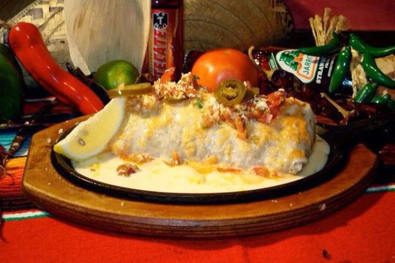 Feeling indecisive about the filling? There's no need to choose between meat or seafood at this Mexican restaurant, where the namesake burrito comes with grilled chicken, steak and jumbo tiger prawns, alongside golden rice, sour cream and onions. The colossal burrito arrives smothered in chipotle cheese sauce and pico de gallo with a side of fried bacon beans and guacamole, making it a serious knife-and-fork kind of meal.