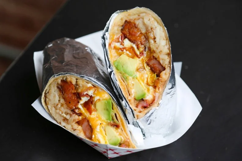 Chef Jordan Andino's cuisine is influenced by his Filipino grandmother's cooking, but presents the flavors and ingredients in a more modern way. At Flip Sigi, a casual taqueria with locations in the West Village and on the Upper East Side, one of the most-popular menu items is the Plan B-Rito, a hangover-busting bundle of three types of pork (longanisa sausage, ham and bacon), hash browns, egg, shredded Mexican cheese and salsa.