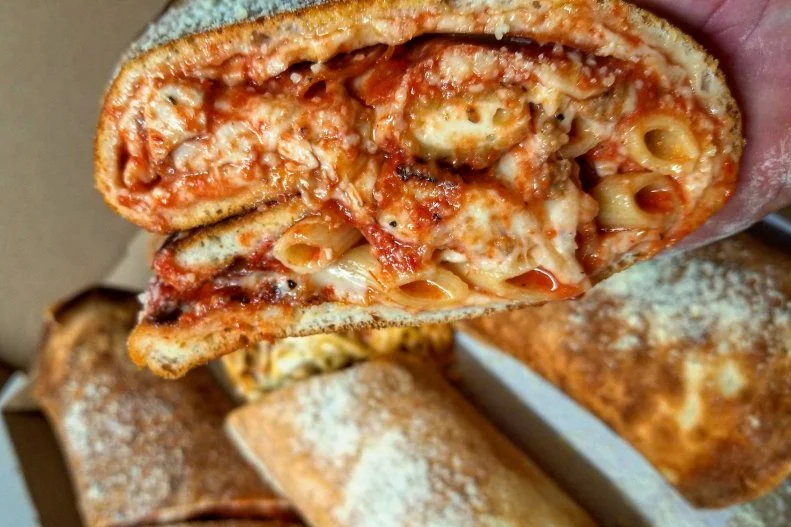 Instead of a tortilla, owner Michael Russo uses his restaurant's signature item, pizza, as a burrito wrapper. Once the bubbling pie comes out of the oven, he layers on other items offered at the New York pizza joint â   pepperoni, chicken cutlet, baked ziti, meatballs and mozzarella sticks â   and rolls it into a cheesy frankenfood that weighs in at an impressive 7 pounds. He's even spun off two variations: the DrunkenRitto, stuffed with chicken Parm, ravioli and vodka sauce; and the GinzoRitto, with sausage, peppers, spaghetti and garlic knots.