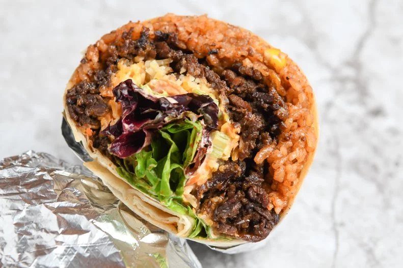 Korean and Mexican flavors come together in this hybrid burrito from Chef David Choi. Diners choose from four proteins — bulgogi beef, spicy pork, chicken or tofu — that get encased in a flour tortilla with the usual burrito fixings of lettuce, cheese and sour cream. In another nod to Choi's Korean-American heritage, the mashup is packed with spicy kimchi fried rice and his top-secret Seoul Sauce.