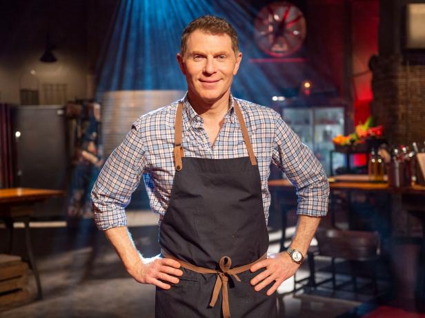 Renowned American Chef Bobby Flay Wearing A Kitchen Apron with Smiley Face