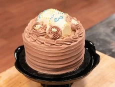 Vertical shot of Peter Tidwell’s German Dark Chocolate Cake with Chocolate Italian Buttercream as seen on Halloween Baking Championship Season 5 Episode 2.