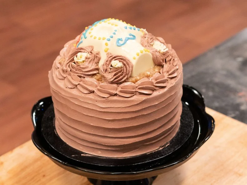 Vertical shot of Peter Tidwell’s German Dark Chocolate Cake with Chocolate Italian Buttercream as seen on Halloween Baking Championship Season 5 Episode 2.