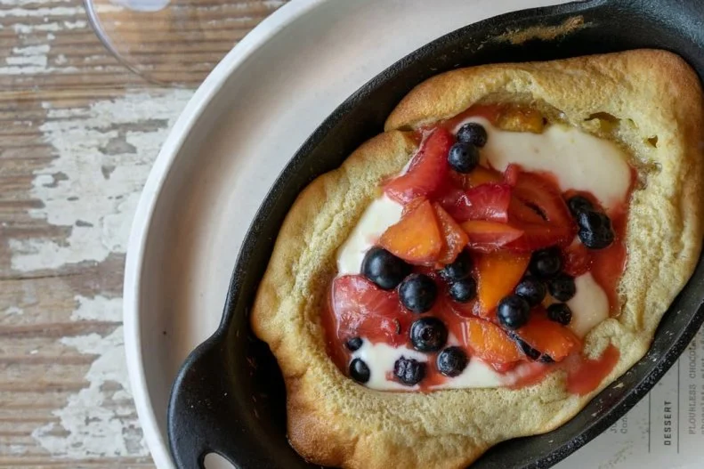 Contemporary Southern cuisine, like country ham arancini with coffee mayo and South Carolina game hen alongside ricotta gnudi, is the focus at South Main Kitchen. The bronzed pancake available at Sunday brunch is a spin on the French fruit dessert clafoutis, cooked and served in a cast-iron skillet. It teems with fruits — roasted fig and cinnamon apple in the autumn, peach and blueberry come summer — and is served atop a bed of tangy Greek yogurt.