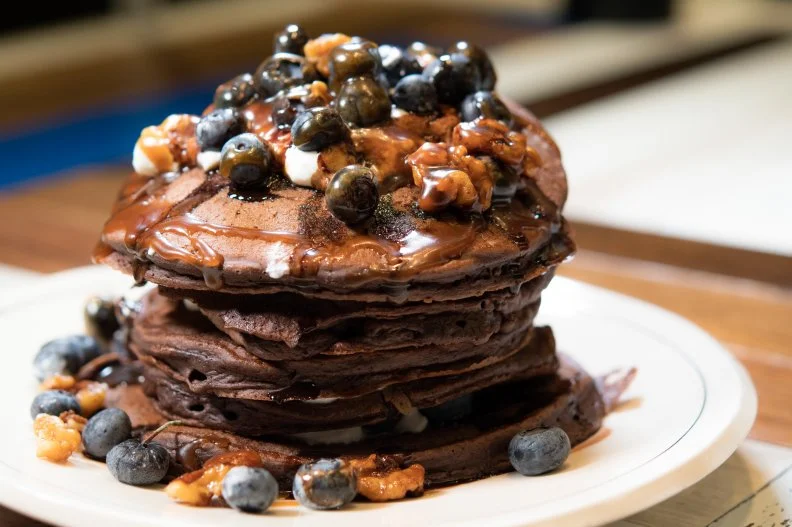 Coffee flour hasn't yet become a household phrase, but James Beard Award-winning chef Jason Wilson is a champion of this nutrient-dense byproduct spawned from the fruit discarded when coffee beans are milled and extracted from plants. He celebrates it on the brunch menu at his farmhouse-inspired restaurant, in forms including cocoa coffee flour pancakes covered in honey-vanilla yogurt, fresh blueberries, maple candied walnuts, and homemade sticky toffee and chocolate sauces.