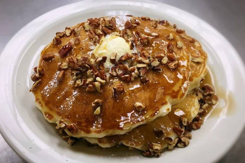Pecans are a beloved staple of South Carolina cooking. In fact, there's even an SC Pecan Trail in Florence, and one of the featured stops is Venus Restaurant & Catering, an institution for more than 40 years. The restaurant's famed pancakes feature the prized nuts both on top — along with powdered sugar and maple syrup — and in chopped form, woven throughout the batter. After enjoying them for breakfast, plan a lunchtime visit for a patty melt and hot fudge cake.