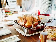 Turkey in roasting pan on table for holiday meal