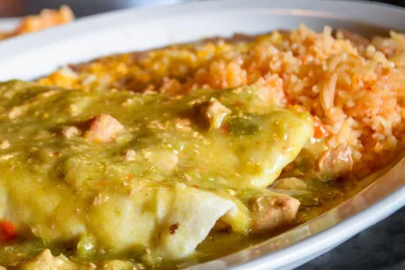 If burrito cravings hit when you're visiting Denver, head to La Loma immediately — and don't forget to bring a hearty appetite. The burrito listed on the menu is actually two burritos, stuffed with either bean and cheese, shredded chicken, ground sirloin or brisket, then smothered with Colorado's famous green chili, red chili or enchilada sauce, and served with rice and beans. Upgrade to the Supreme version to add a dose of melted cheese, sour cream, lettuce, onions and tomatoes.