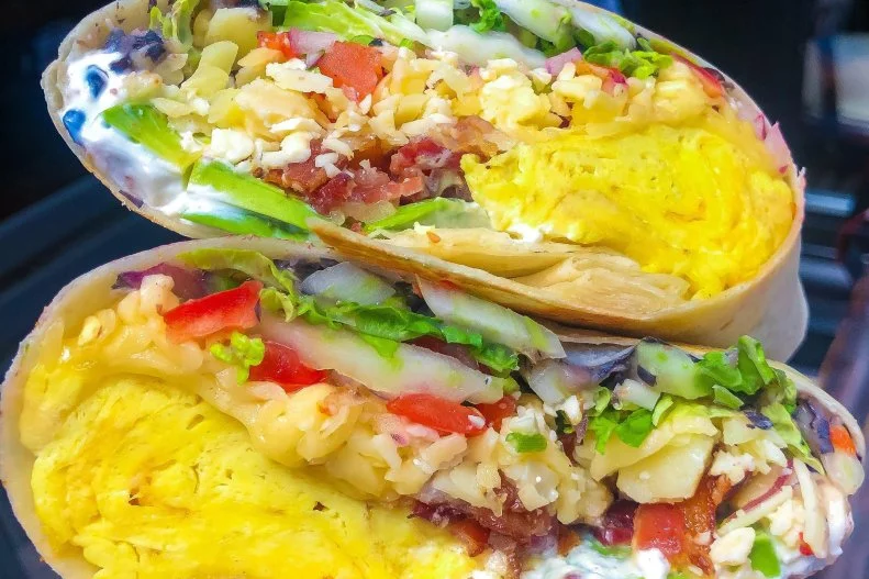 At MAD Social in Chicago, weekend brunch is an opportune time to feast on the beloved,  oversized breakfast burrito. Expect a flour tortilla filled with soft-scrambled eggs, black bean puree, pico de gallo, avocado, sour cream, napa cabbage and Chihuahua cheese. Chef Josue Salmeron's suggestion for meat lovers? "Add on both bacon and steak."