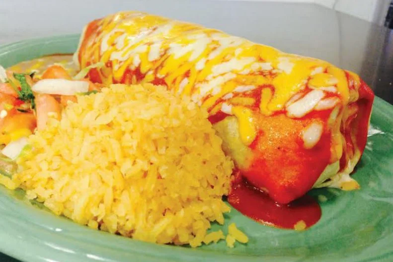 If you find yourself in Frederick, Maryland, mosey over to Cafe Bueno for one of the authentic Mexican burritos, which have won the spot countless awards. Meat, cheese, sour cream and beans are rolled in a large flour tortilla, topped with sauce and melted cheese, and served with rice and beans. There are countless different ways to enjoy a burrito here; no matter which you choose, you can be assured that the meat will be hand-cut, marinated in-house and cooked to perfection each time.