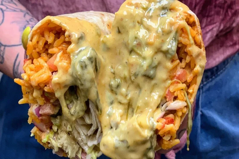 If you're in Binghamton, New York, run, don't walk, to Dos Rios Cantina to sink your teeth into the carnitas burrito. If the image alone doesn't entice you, its description will: a flour tortilla overstuffed with carnitas, house rice, pico de gallo, pickled shallot and lettuce. The most-awesome part? It's smothered in creamy queso.