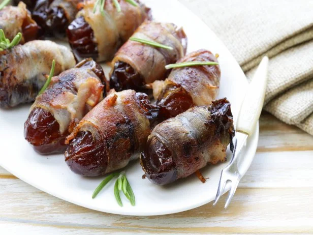 appetizer delicacy dates wrapped in bacon and fried