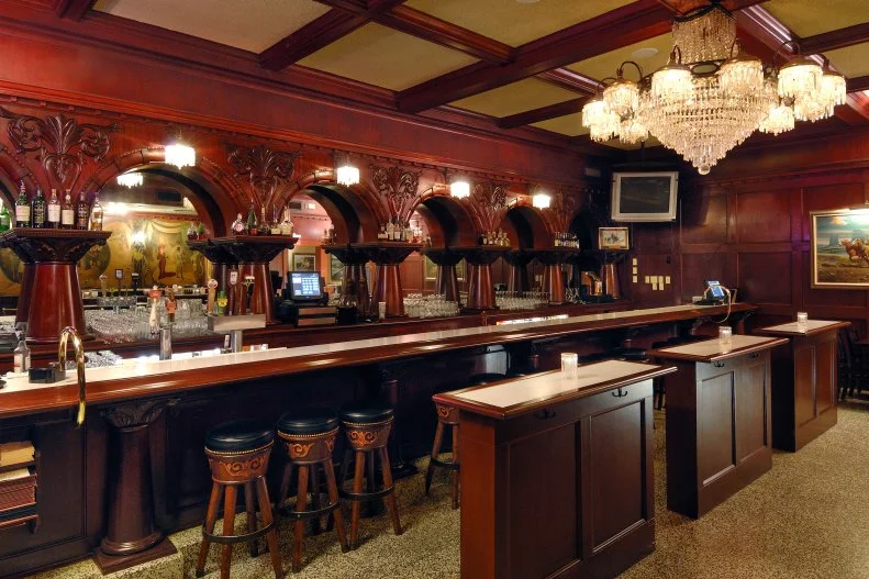 The Stockyards Restaurant & 1889 Saloon, aka Arizona’s Original Steakhouse, was originally built as Stockyards Café in 1947 to feed the cowboys working Phoenix’s actual stockyards. After a major fire destroyed most of the original building in 1953, the restaurant was rebuilt in 1954 as a steakhouse called Stockyards Restaurant and Bar 1889, complete with oversize cushy booths, a hand-carved mahogany bar and cattle-brand chandeliers. The classic steakhouse spirit remains — as do actual spirits. In the Saloon, many bar patrons have seen an apparition of the “lady in the red dress,” who is also depicted on one of the wall murals behind the bar (pictured above). And one cleaning crew vowed never to come back after they saw a ghost crouching in the corner. For a slice of history without the spooks, ask for booth 26 in the Gold Coast room, beloved by John Wayne and Barry Goldwater, who were regulars. Feast on signature dishes like slow-roasted prime rib or Paloma Ranch calf fries, lightly breaded and deep-fried veal testicles. It’s a nod to the Stockyards circa 1950 when bulls were converted to steers and cowboys traded testicles for whiskey across the bar.