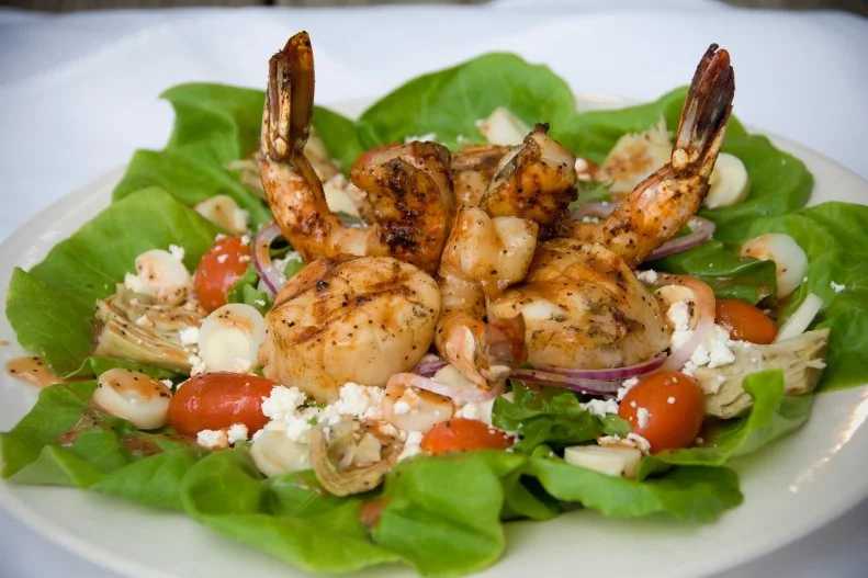 For fresh Southern coastal seafood with a side of spookiness, look no further than The Live Oak on Howe. It’s located in Southport, a historic town in N.C.’s Brunswick Island, inside a charming turn-of-the-century home complete with original pine floors and antiques such as English pub tables and chairs. It’s also home to a few spirits, including a young girl who once lived in the home, as well as wandering spirits passing through town. Chef-owner Sean Mundy has experienced his fair share of strange happenings, including witnessing the side door opening and closing on its own, items falling off the cabinets, and a clock springing from the wall. The Live Oak operated as a restaurant for 15 years, showcasing Mundy’s fine dining flair imbued with a Cajun twist (think shrimp and scallop salad or blue crab dip and alligator bites). These days, Mundy is focused on events and catering, but often hosts special dinners — including ones that honor the house’s paranormal activity. Book a seat for one of the Ghost & Gourmet dinners, which even includes a personal reading with a psychic medium.