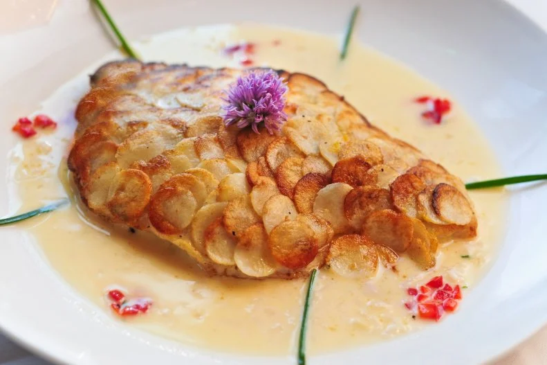 The Brentwood, located in Little River, a sleepy fishing town in low country, is known for chef Eric Masson’s top-notch takes on local seafood. To wit, Shrimp & Scallop Chardonnay teams up dayboat U10 scallops and shrimp with angel hair pasta in a creamy leek fondue and Chardonnay wine sauce. The intimate space and subtle lighting set a romantic mood, but you may be joined by some uninvited guests. The most famous is a spirit known as the Shadow Figure, who typically haunts the stairwell and the second floor’s front dining room (and has been sighted by owner Kim Masson). Then there’s the Civil War soldier who parades in front of the window in the back room. It’s believed that he came to the restaurant with the wood that was used as the flooring here, which originally came from a cotton mill in Georgia that was used as an armory during the Civil War. Hold on to your earrings — if you lose them, they could’ve been taken a small boy with a penchant for shiny objects (though he’s been known to return them when offered a different pair left overnight on the bar in the bistro).