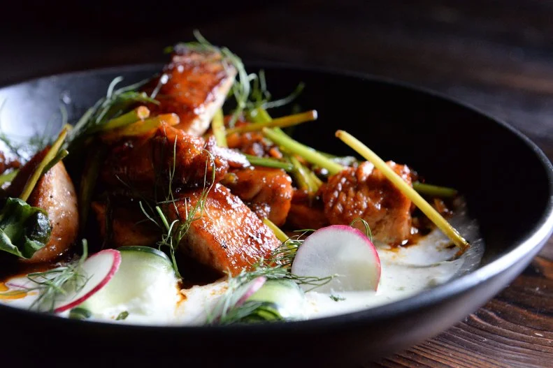 When brothers Peter and Tien Tran found the location for Ambrosia, their Southeast Asian-inspired Houston restaurant, they knew there was something special about the building’s ambiance. The mood lends itself to the sultry design, outfitted with iron lanterns, a backlit fountain anchored by a roaring lion and lush tropical plants. It also sets the scene for a vibe of another kind — a spooky one. Staff often report feeling like they’re being watched and when alone, they hear things moving around and see kitchen utensils moving around out of the corner of their eye. Some have even heard their names being called out, despite being alone. There’s even a video of the frozen margarita machine’s toggle switch flipping on by itself. It’s more ambiance than the Trans bargained for, but you scan score a bargain of your own during Ambrosia’s daily happy hour specials. From the food menu, don’t miss the Tom Yum shishito peppers with hot and sour sauce or the tamarind salmon with pad Thai glaze and cucumber ribbons.