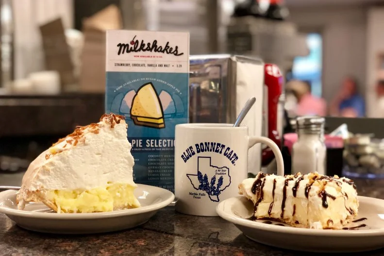 The Blue Bonnet Cafe — named for the hat, not the popular Texas wildflower — originated in 1928 on Main Street in Marble Falls and moved to its current location on Highway 281 in 1946. It has remained a staple for locals and visitors alike, and has been family-owned since 1981, when John and Belinda Kemper took over the operation. Many of the staff have been with them for more than 25 years, and the Kempers' oldest daughter, Lindsay, and her husband Dave, joined the team in 2005. The customers have their own legacy too — one couple celebrated their honeymoon at the Blue Bonnet and have returned every year since during their 60-plus-years of marriage. The Blue Bonnet prides itself on home-cooked dishes like pot roast, chicken-fried steak and liver with onions, but its claim to fame is pie. The diner's two-sided pie box case boasts 14 different pie flavors available daily (don't miss the fan-favorite coconut cream), and the diner even celebrates pie happy hour every weekday from 3 to 5 p.m. The pies are so irresistible that thieves even stole whole pies during a burglary at the diner in 1931 (as reported by The Burnet Bulletin).