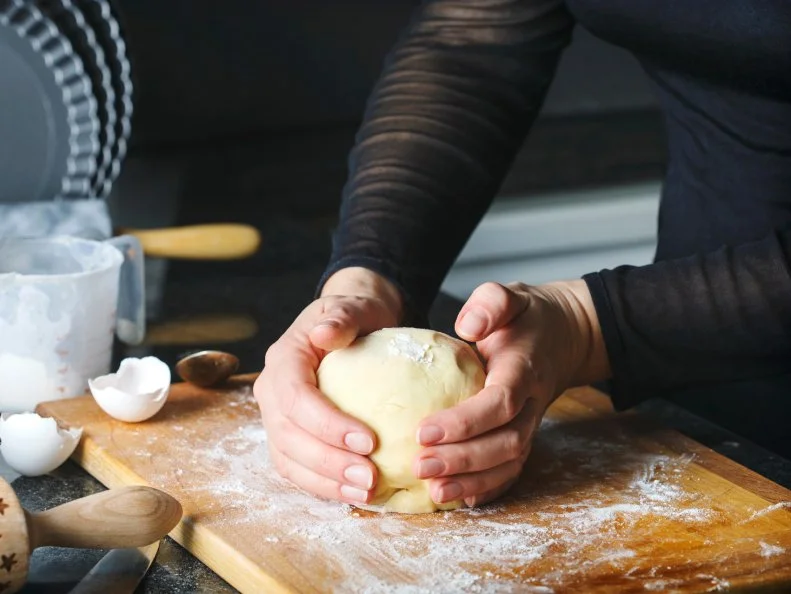 Woman making a flaky pastry dough