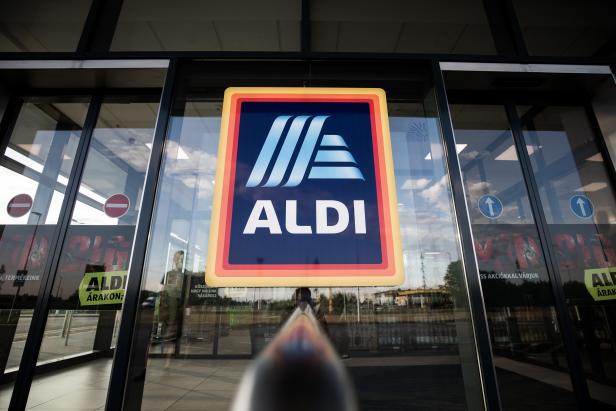 A sign hangs at the entrance to an Aldi Stores Ltd. grocery store in Ullo, Hungary, on Monday, July 8, 2019. Aldi, known for its spartan approach to retailing, plans to make all of its private-label packaging reusable, recyclable or compostable by 2025, while cutting packing materials for those products by 15 percent over the same period. Photographer: Akos Stiller/Bloomberg via Getty Images