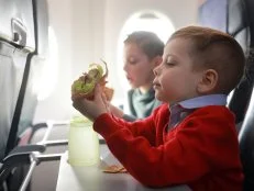 Portrait of children eat on the plane