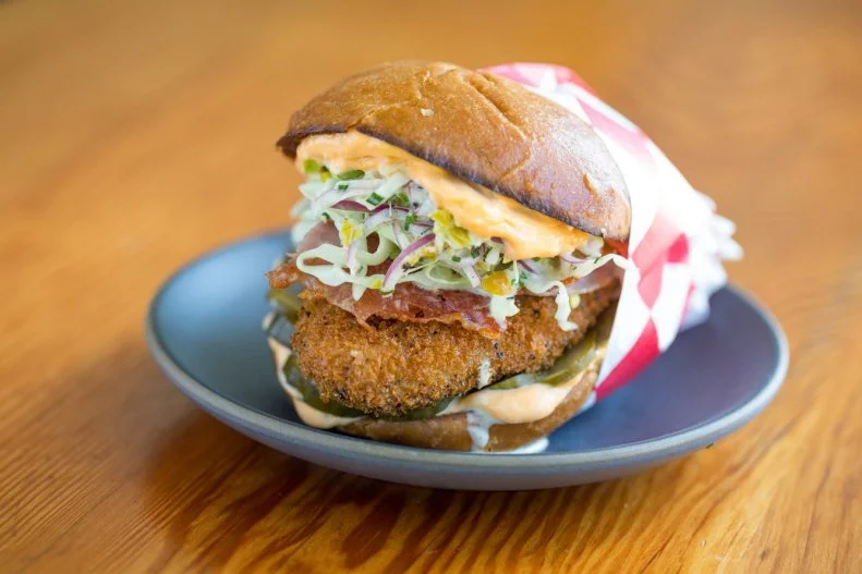 As with many things food-related, the Italians have their own delicious version of a fried chicken sandwich. Milanese is a style of preparation that features floured and breaded meat (the term doesn't just apply to chicken) fried in oil until golden brown. Alimento in Silver Lake has developed a cult following for its version. For brunch, Chef Zack Pollack serves his breaded chicken thigh in the style of a Milanese cutlet, nestled in a light brioche bun toasted with olive oil and topped with thinly sliced prosciutto cotto along with pickles, fresh pepperoncini slaw and a bit of Calabrian chile mayo for some heat.