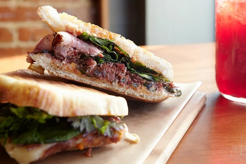One would be hard-pressed to find a more indulgent sandwich filling than duck confit. Confit is a classic French preservation method in which succulent duck is cooked and cured in its own rendered fat. The meat ends up full of savory flavor, with a texture so moist and tender it really does practically melt in the mouth. Duck confit sandwiches can be found on gastropub menus across the U.S., but it would make sense that a place called Duckfat would have some of the best fat-cured duck around. Its overnight duck confit panini combines rich poultry with chewy bread baked daily by nearby Sorella’s Bakehouse. The current iteration features charred cabbage, cilantro and black garlic mayo, but the place offers special variations at times, like the version with house-smoked brisket and Chinese broccoli.