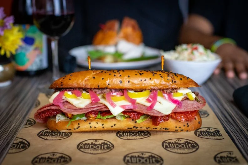 Ham and cheese is one of the most-classic sandwich filling combinations in the United States. But many Italian-Americans like it hot, so they swap out mild ham for spicy salami. Greg Mudge, owner of Mudgie’s Deli & Wine Shop in Detroit, is one of those folks. His version, which he calls Leggo, is one of his personal favorites. It features hot Genoa salami, Asiago cheese, housemade olive tapenade, pepperoncini, pickled red onion, roasted tomatoes, romaine lettuce and mayo on a fresh-baked Italian hoagie made at nearby Golden Wheat Bakery.