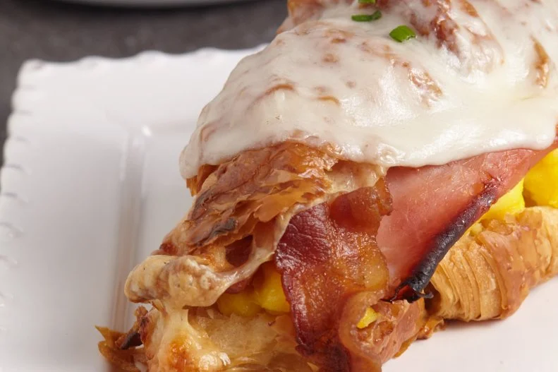 If every major fast-food chain has a version, you know it's a classic American dish. That’s certainly the case with the croissant breakfast sandwich — at least at chains that serve the first meal of the day. Forgo the drive-through version in favor of a chef-prepared take such as the breakfast sandwich at Nathaniel Reid Bakery in Kirkwood, Missouri. It's been hailed as one of the best breakfast sandwiches in the food-loving St. Louis area. Reid layers farm-fresh soft-scrambled eggs (which have an airy, quiche-like consistency) with ham, smoked bacon and Havarti inside one of the bakery’s renowned croissants that take four whole days to make. Melted cheese and chives add another creamy and vibrant touch.