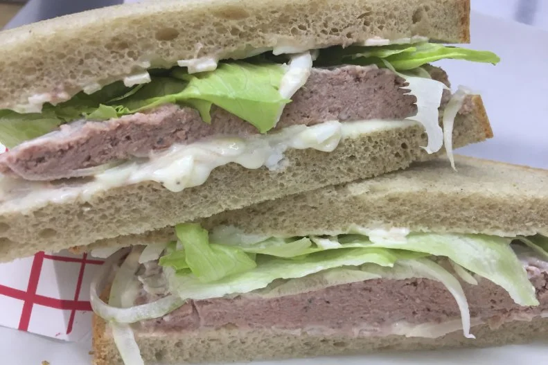 When Germans crossed the pond to the United States, they brought their favorite dishes from home, many of which have since been adopted as part of the American culinary canon. The liverwurst sandwich is one such staple. Raw, uncut livers are run through a meat grinder until creamy like peanut butter, stuffed into a casing, cooked and sandwiched between two slices of bread. Werner’s Fine Sausages in Mission, Kansas, makes its Old World-style liverwurst by hand in small batches. They cook pork and onions, add the liver and mix it with spices, stuff it into casings and sous vide the whole thing. It’s sandwiched between slices of seedless rye with mayo, onions and lettuce.