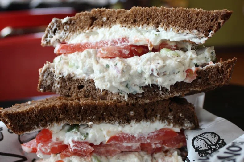 Randy Hampton, a dropout Ph.D. candidate in chemistry who came to work in Zingerman’s Deli's kitchen, inspired this whitefish salad sandwich. The former aspiring comedian, now a successful Ph.D. chemist who runs a lab at the University of California, San Diego, is the Randy in Randy’s Routine. Smoked whitefish from Mackinac Straits Fish Co. is hand-picked off the bone and mixed with rich sour cream, mayonnaise, onions and fresh dill, then layered with scallion cream cheese and tomato on pumpernickel bread from Zingerman's Bakehouse. It was one of the first sandwiches on the university town deli’s menu — and it’s still a top seller.