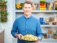 Bobby Flay posing with Spicy Lemon Spaghetti w/ Lobster & Breadcrumbs, as seen on Food Network Kitchen Live.