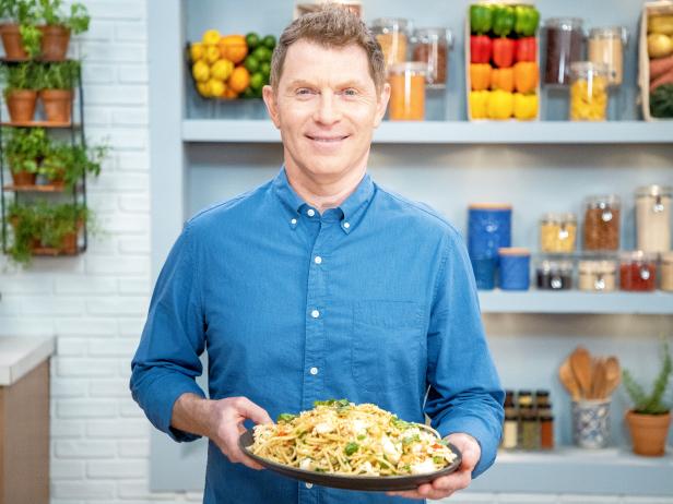 Bobby Flay posing with Spicy Lemon Spaghetti w/ Lobster & Breadcrumbs, as seen on Food Network Kitchen Live.