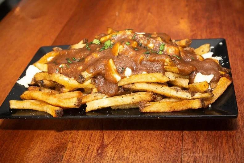 Seattle's only hockey bar pledges allegiance to Canada, by celebrating that nation's most-popular sport (airing World Cup, World Jr. and Olympic games) as well as its signature eats. Think BLTs stacked with peameal bacon, Montreal smoked-meat sandwiches and, of course, indulgent poutine that's available in flights â   $15 buys you three beaver dams worth of hand-cut fries, Beecher's cheese curds and your choice of three gravies.