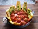 Host Rachel Ray's Roasted Meatballs and Garlic Bread, as seen on 30 Minute Meals, Season 28.