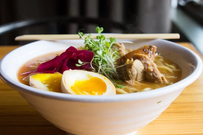 The concept for Dashi began when Billy and Kelli Cotter hosted a pop-up at The Cookery, a culinary incubator owned by Rochelle Johnson and Nick Hawthorne-Johnson. When the fervor for reservations caused The Cookery's website to crash, it became clear that Durhamites had an insatiable appetite for Japanese fare. The foursome created Dashi, a two-level restaurant with a bustling ramen shop on the ground floor and an izakaya, or Japanese pub, upstairs. Wherever you choose to dine, you'll want a bowl of ramen to slurp. Sit at the ramen counter downstairs for a glimpse of the action, or settle into one of the cozy tables along the Japanese manga-adorned walls. Broth is the foundation of a good bowl of ramen — dashi is the name of the Japanese mother broth — and you can't go wrong here, whether you opt for the milky, porky tonkotsu, soy-based shoyu, funky-spicy kimchi, punchy miso or shio (sea salt). At dinner, head upstairs to the denlike izakaya for small plates that marry North Carolina flavors and ingredients with Japanese techniques, like spicy peanuts boiled in soy sauce, mirin and ginger. There's also an excellent assortment of yakimono — skewered meats and vegetables such as miso eggplant, bacon-wrapped mochi and chicken heart — alongside snacks such as spicy miso chicken wings and curried beef tendons fried into puffy crackers. Wash it all down with a highball of Japanese whiskey, lemon and soda water or a seasonal frozen chuhai, a boozy slushie made with shochu and fruit juice. The Cotters' other restaurant, Toast, is a perennially popular spot for perfectly pressed paninis.