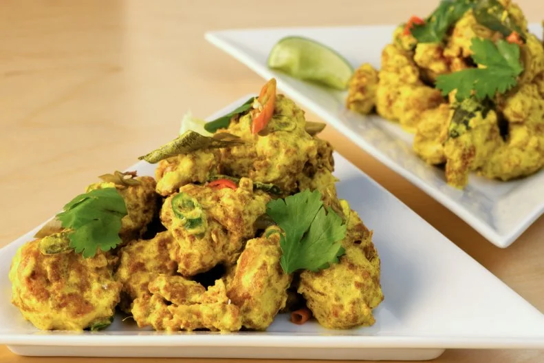 In an era when chefs have become the new rock stars, Chef-Owner Cheetie Kumar is a singular talent who is both. Before she started winning national recognition and James Beard Award semifinalist nods for her Indian- and Asian-inspired cooking at Garland, she was more likely to be applauded for her talents in local band Birds of Avalon. Though she still finds time to practice and play with her band (and tinker with the restaurant's soundtrack), these days you're more likely to find her in the kitchen creating dishes inspired by her native India and by North Carolina ingredients. To start, don't miss the crowd-favorite Cauliflower 65, composed of lightly fried florets redolent of ginger and garlic and finished in a turmeric-yogurt sauce. The menu changes seasonally, but dishes seamlessly meld Southern and Indian influences. To wit, giant, shell-on North Carolina shrimp coated with green coconut chutney is a hybrid of peel-and-eat shrimp and black pepper shrimp, and it's served with charred okra and onions, a classic combo in both cuisines. Wash it down with a Magdalena, an off-menu tamarind margarita, or head downstairs for a nightcap at Neptunes Parlour, where you can channel your inner rock star during karaoke Tuesdays. If you'd rather leave the singing to the pros, head upstairs for a show at Kings.
