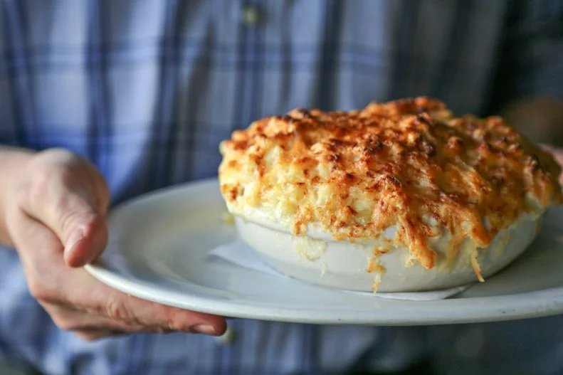 You'd be hard-pressed to find anyone, among City of Oak natives and transplants alike, who doesn't gush about Poole's. They're likely to first tell you about the Macaroni au Gratin, a locally famous baked mac-and-three-cheese dish that's listed as a side but is so good that people have been known to order it as an entree. Then they'll get to debating the merits of sitting at the double horseshoe bar or snagging a cozy red leather banquette, and talking about how, beyond the mac 'n' cheese, it's nearly impossible to choose what to order from the chalkboard menu. Poole's is named for the diner that once occupied the space, and while the menu may take inspiration from classic comfort foods, the contemporary spin and thoughtful ingredients are all from chef, restaurateur and James Beard Award winner Ashley Christensen. You really can't go wrong here, whether you're in the mood for, say, a tea-brined pork chop, leg-of-lamb meatloaf or even a simply dressed Bibb lettuce salad. If it's summer, don't miss the tomato pie, a wedge of tomato and cheese layers barely contained in crust. But more than the food, more than the ambiance, what makes Poole's … well, Poole's … is the hospitality. In fact, all of Christensen's restaurants give you a sense of what Southern hospitality is all about —a feeling of warmth, of being taken care of. You'll find it whether you're brunching on fried chicken and biscuits at Beasley's Chicken & Honey, making a pitstop for pork-chili-topped burgers at Chuck's, splurging on wood-fired aged steaks at Death & Taxes or sipping a late-night craft cocktail at Fox Liquor Bar. It feels like home.