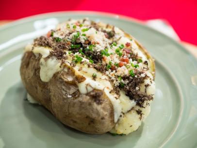 Geoffrey Zakarian makes a Loaded Baked Potato with Truffle, Bacon, and Chives, as seen on Food Network's The Kitchen