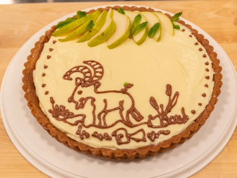 Contestant Davis Sams' completed dish from the main bake, Sable tart with milk chocolate, goat cheese pastry cream, and caramelized pears, as seen on Kids Baking Championship, Season 6.