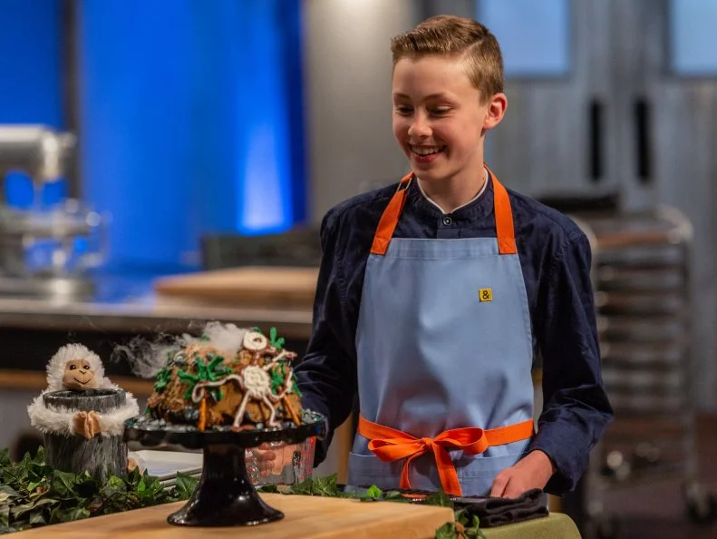 Contestant Davis Sams presents his dish from the main bake to the judges, as seen on Kids Baking Championship, Season 6.