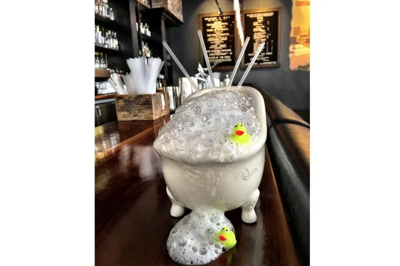 The team at this Downtown cocktail parlor has given the term "bathtub gin" a whole new meaning. The Duck Bath Punch is a playful ode to the creative spirits making of the Prohibition era, but there's nothing makeshift about the shareable sipper. A mini ceramic tub is filled with Hendricks gin (of course), amaro, Grand Poppy liqueur, Earl Grey tea and grapefruit oleo. To mimic a true bath, the tub is topped with cucumber air that looks just like soaking bubbles.