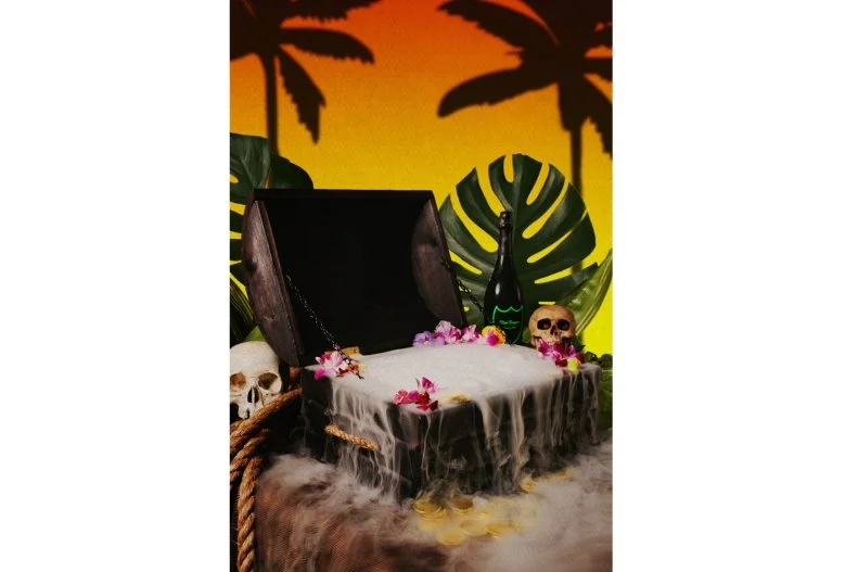 When the Treasure Chest hits the floor, all eyes are on it. It's impossible not to stare as the massive alcohol-filled trunk makes its way around Three Dots and a Dash â   which is exactly what beverage director Kevin Beary intended. A blend of fresh fruit juices, three types of rum and a whole bottle of Dom Perignon, the group cocktail is garnished with loads of tropical fruit, orchids and â   because it is a treasure, after all â   shiny gold coins.