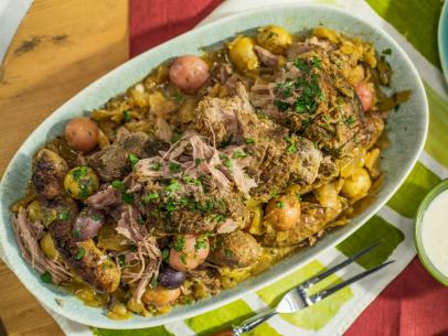 Geoffrey Zakarian makes Braised Pork Butt with Mustard, Cabbage, and Italian Sausage, as seen on Food Network's The Kitchen