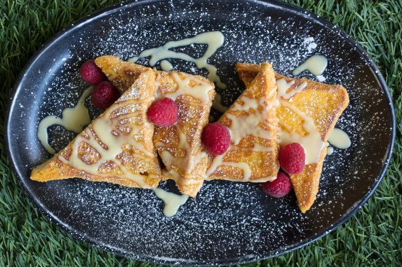 Two breakfast classics unite in this sugar-packed dish at Culinary Dropout. Bread is dipped in cereal milk custard, then covered with crushed Cap’n Crunch cereal, fried and then drizzled with more custard( $8). There’s a side of maple syrup for anyone who wants to add even more sweetness.