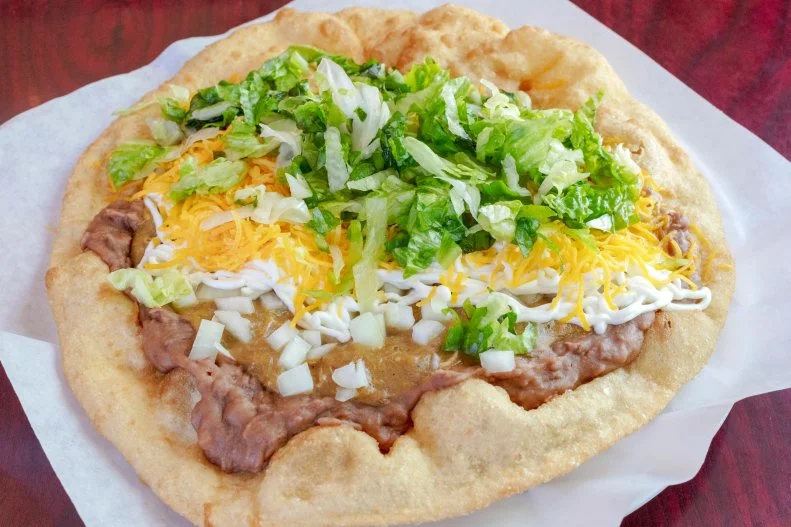 These deep-fried, fluffy bread-based tacos are about the size of medium pizza, folded over. Fry Bread House’s Ultimate Taco ($9) is topped with a generous portion of beans, red or green-chili beef, onions, lettuce, sour cream and yellow cheese.