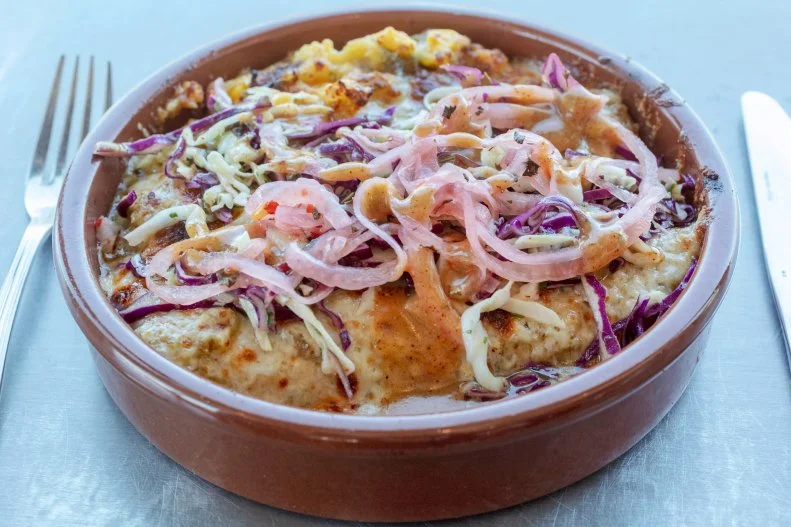 Gadzooks! It’s an enchilada craze! This soup and enchilada spot has cafeteria-style line where diners pick between house-made, freshly pressed corn or corn/flour blend tortillas, with a choice of fillings. Next, it’s time to choose between red or green enchilada sauce, cheese and an optional egg on top (the addition of which still keeps the price under $10). The platter goes into the wood-fired oven before it’s time to pick cold toppings like slaw and pickled red onions.