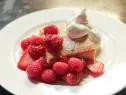 Close-up of Tres Leches Cake with Berries and Whipped Cream, as seen on Barefood Contessa: Back to the Basics, Season 16.